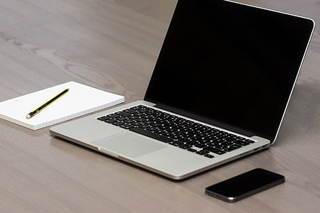 MacBook Pro beside white notebook and gold fountain pen thumbnail