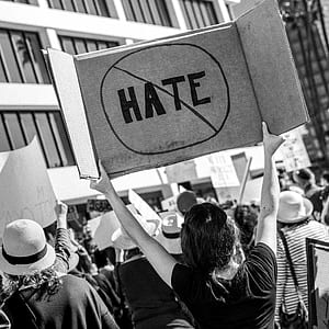 person raising signage no hate thumbnail