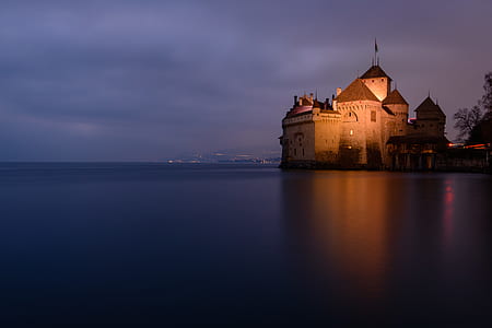 brown concrete building near body of water thumbnail