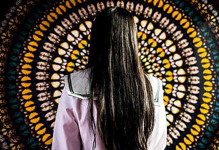 woman standing in front of wall decor thumbnail