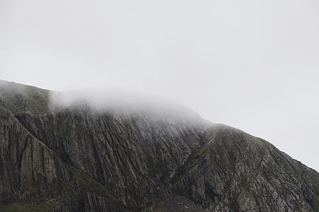 rock mountain covered with white fog thumbnail