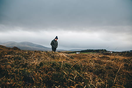 man walking on green grass field thumbnail
