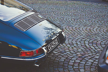 blue Porsche parked near vehicle thumbnail
