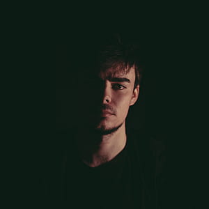 man wearing black shirt on dark place thumbnail
