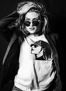 grayscale photo of woman in black coat and black sunglasses with black frames thumbnail