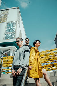 three person standing on stairs outside building thumbnail