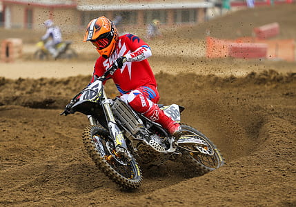 man riding motocross dirt bike on muddy road thumbnail