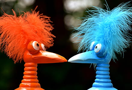 close shot of orange and blue bird plastic toys thumbnail