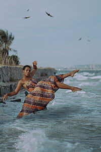 time lapse photography of woman above body of water thumbnail