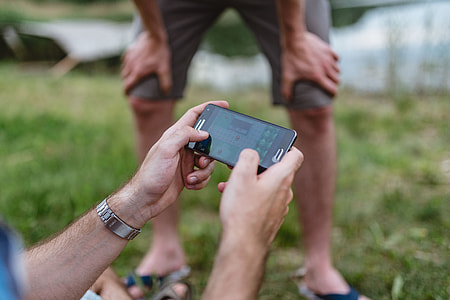 Closeup of man hands playing videogames on cell phone thumbnail