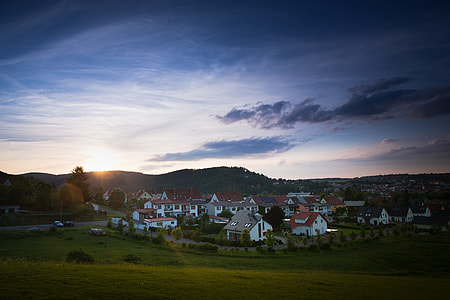white and brown houses under cloudy sky thumbnail