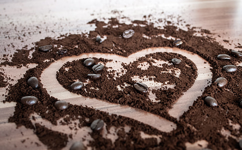 macro photography of powdered coffee beans and seeds forming heart thumbnail