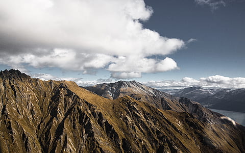 rocky mountain under cloudy sky thumbnail