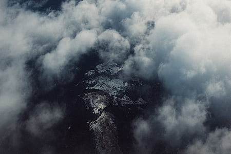 brown rocky mountains under white clouds thumbnail