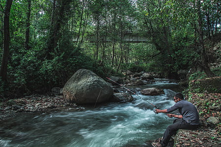 man fishing near river thumbnail