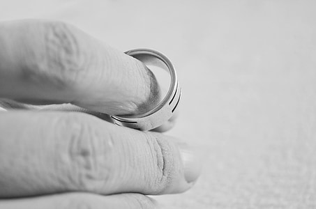 person holding silver-colored ring thumbnail