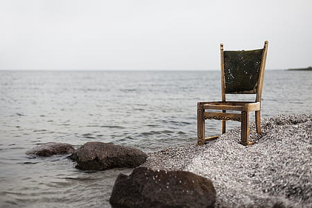 brown wooden chair on seashore thumbnail