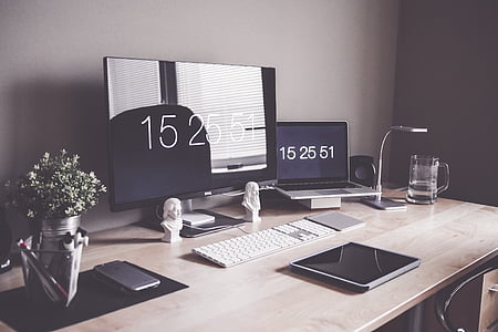 computer monitor beside laptop on table thumbnail