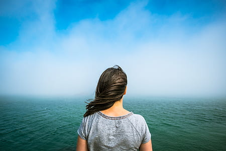 woman facing body of water thumbnail