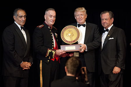 Donald Trump holding award with three men thumbnail