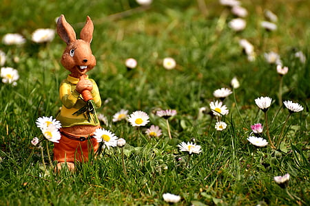 brown rabbit figurine on grass field thumbnail