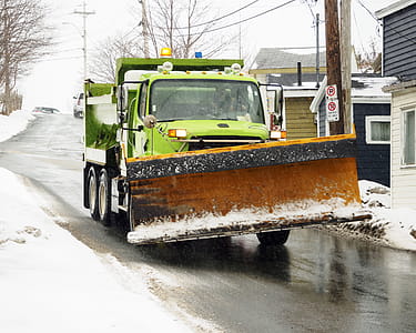 Snow plow truck salting roads before a snow storm. thumbnail