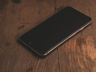 space gray iPhone 6 displaying black screen on brown wooden surface thumbnail