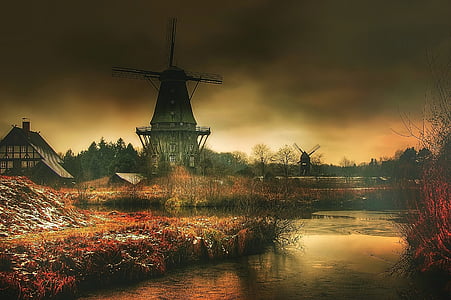 black and gray windmill beside body of water painting thumbnail
