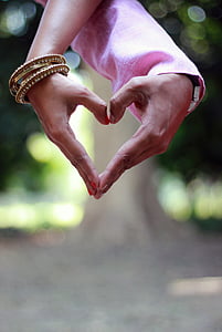 couple's hands forming heart gesture thumbnail