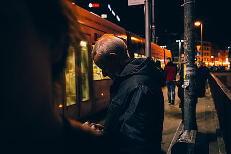 man standing near train thumbnail