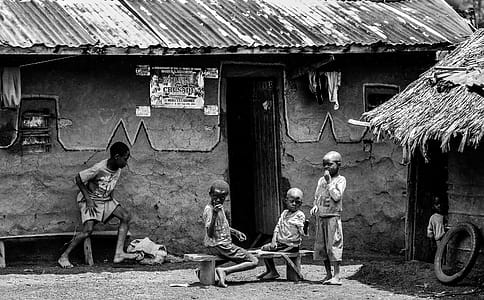 Greyscale Photo of Children in Front of a House at Daytime thumbnail