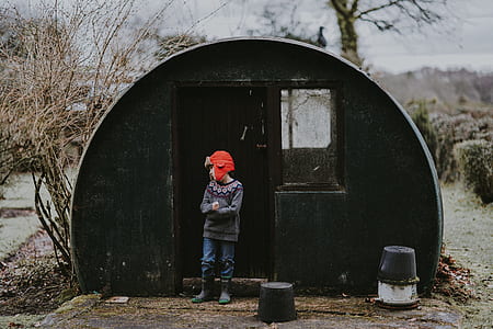 man standing outside cabin during winter thumbnail