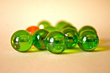 tilt shift lens photography of green marble balls thumbnail