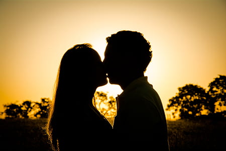 silhouette of couple kissing thumbnail
