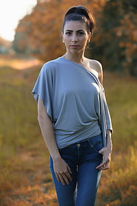 woman wearing grey off-shoulder blouse and blue denim jeans thumbnail