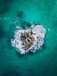 aerial photography of stone in the middle of sea thumbnail