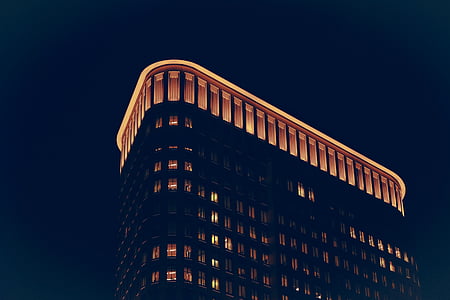 high rise building with lights turned on thumbnail