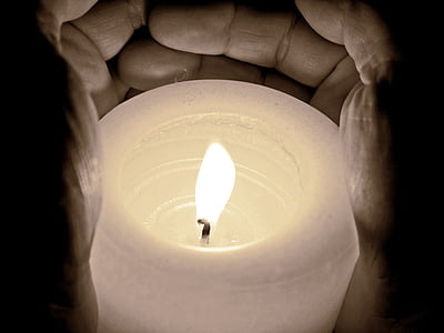 person holding pillar candle thumbnail