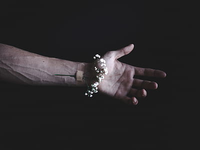 person's arm with white flowers and band aid thumbnail