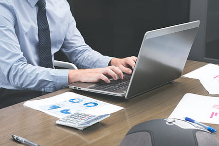 Office Staff Typing On Laptop Photo thumbnail