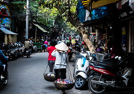 man walking while carrying wooden buckets thumbnail