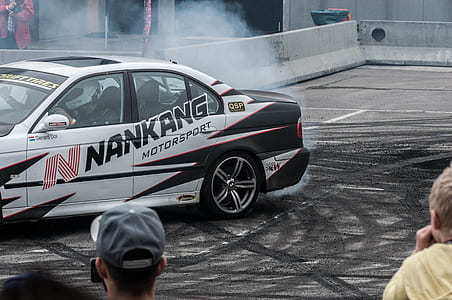 white and black sports car drifting thumbnail