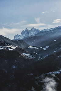 rocky mountain covered by snow with trees thumbnail