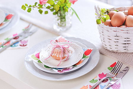muffin on white ceramic saucer near vase thumbnail