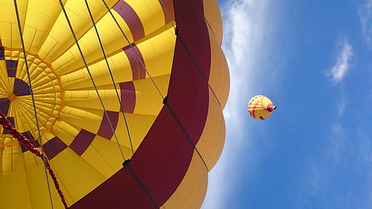 yellow and red hot air balloon in air thumbnail