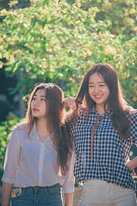 Woman Standing Near Woman Beside Trees thumbnail