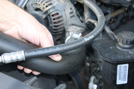 person holding black Parker vehicle engine hose thumbnail