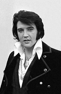 grayscale photo of Elvis Presley in black suit jacket thumbnail