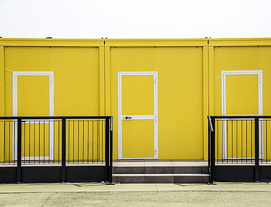 yellow and white doors near black metal hand rails thumbnail