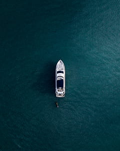 aerial view photography of white boat on body of water thumbnail